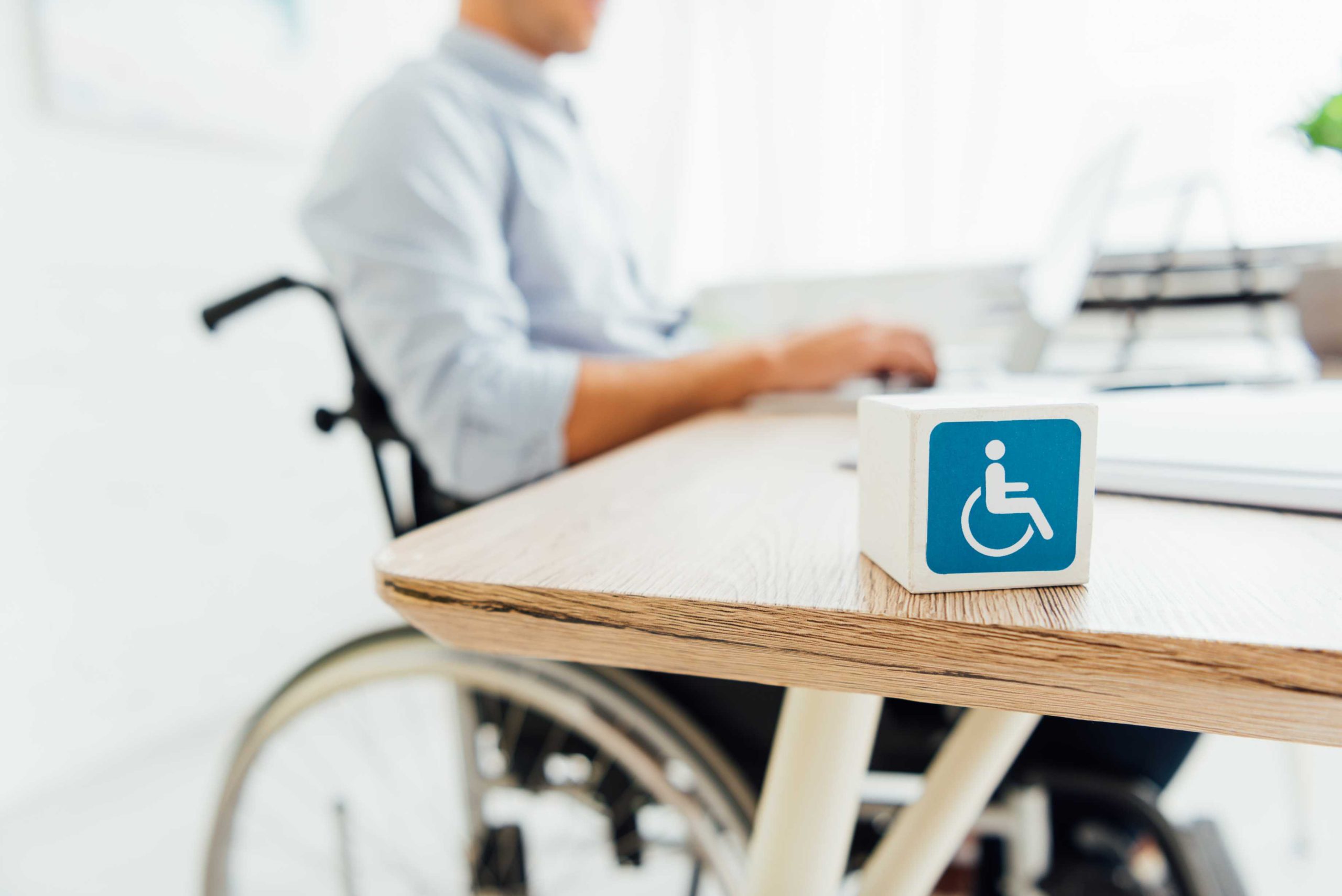 selective-focus-of-cube-with-disabled-sign-and-man-2026-03-11-03-28-05-utc